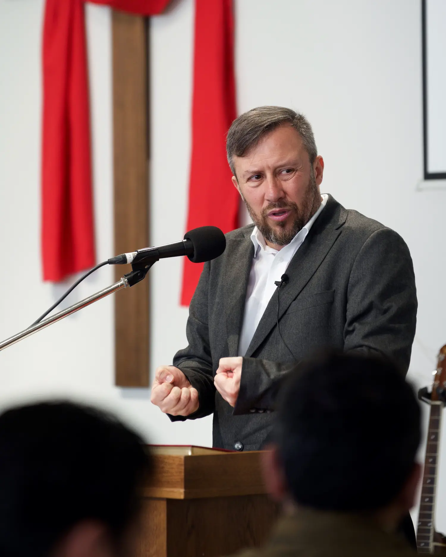 Pastor Nikola Galevski preaching from the pulpit at Soulcraft Church