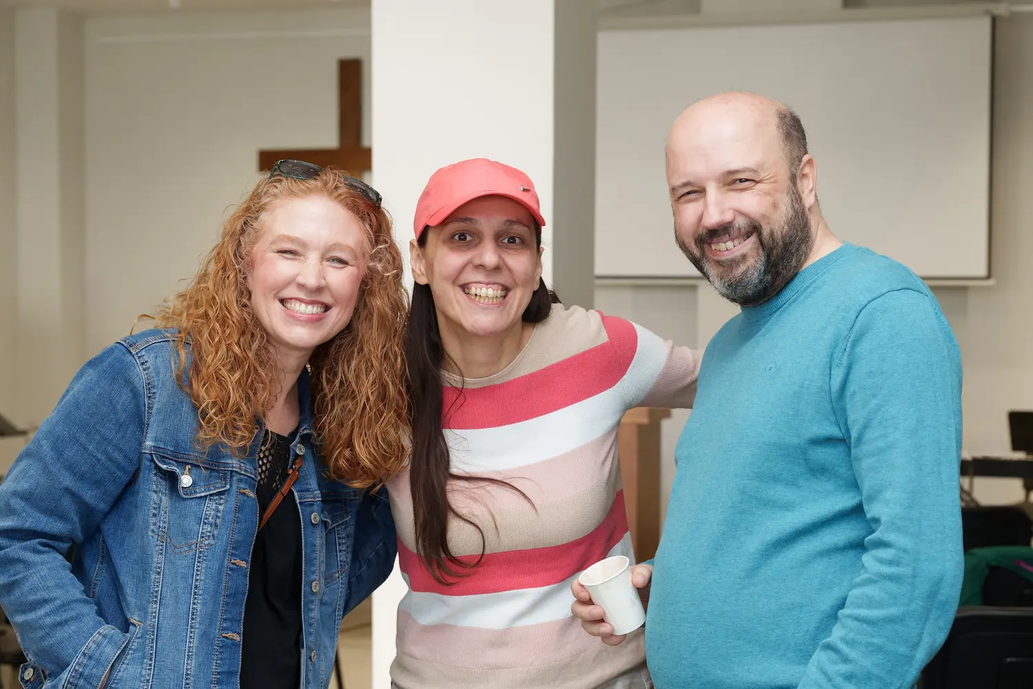 Three friends smiling together at Soulcraft Church
