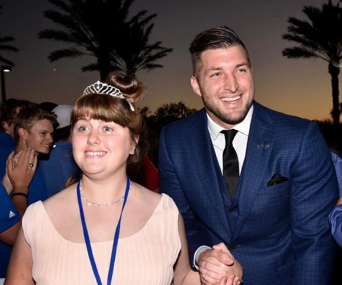Tim Tebow walking a princess down the red carpet at Night to Shine